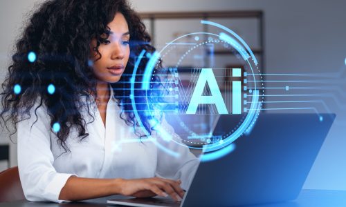 Portrait of beautiful young African American businesswoman using laptop in blurry office with double exposure of futuristic AI artificial intelligence interface. Concept of machine learning